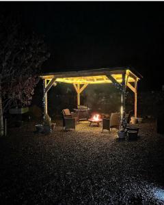 a pavilion with chairs and a fire at night at Loch Ness Pods, Pod 2 in Fort Augustus