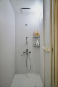 a bathroom with a shower with a hose in it at Foresta Karuizawa 2 in Oiwake