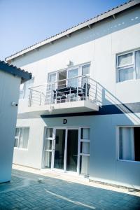 a white building with a balcony at AS Guesthouse & Self-catering in Swakopmund