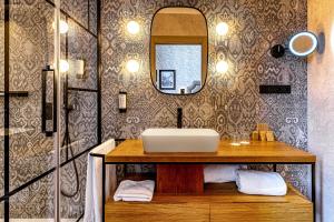 a bathroom with a sink and a mirror at Boutique Hotel Cordial Plaza Mayor de Santa Ana in Las Palmas de Gran Canaria