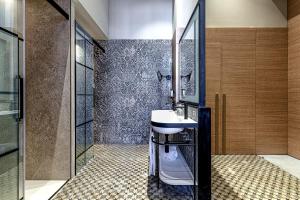 a bathroom with a sink and a shower and a toilet at Boutique Hotel Cordial Plaza Mayor de Santa Ana in Las Palmas de Gran Canaria