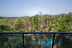 a view from the balcony of a resort with trees at Palolem Luxury Apartments in Canacona