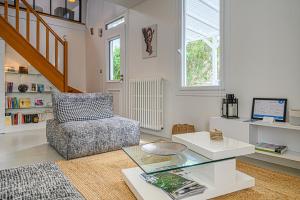 salon z krzesłem i szklanym stołem w obiekcie Imagine - Charmante maison avec jardin w mieście Vannes