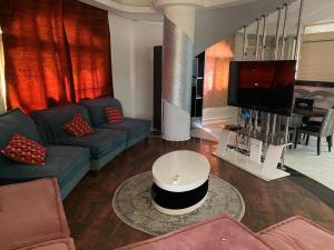 a living room with a couch and a table at Luxury apartment in front of the AUC in Cairo