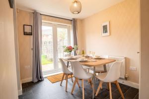 a dining room with a table and chairs and a window at Saltbox Stays - 3 Bed with off-street parking, fast Wifi, sleeps 7, Central location in Ashby de la Zouch