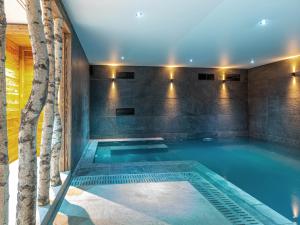 a swimming pool in a house with a tree at Chalet Val-d'Isère, 8 pièces, 12 personnes - FR-1-694-3 in Val-d'Isère