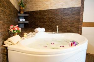 a bathroom with a tub with flowers in it at Patong eyes in Patong Beach