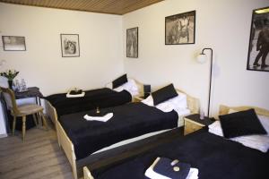 a room with two beds and a table with a table at Zum Burgkeller in Bruchweiler +16 photos