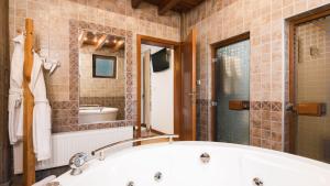 uma casa de banho com uma banheira, um chuveiro e um lavatório. em Chalet Balkan em Valevtsi