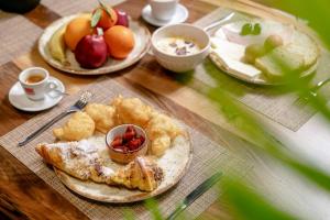 a wooden table with plates of food on it at Elegance Boutique Hotel in Korçë