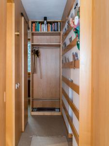 a hallway with a door and shelves with books at Mandron charming and central apartment in Madonna di Campiglio