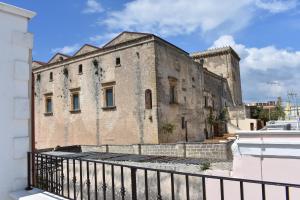 an old stone building with a fence in front of it at Casa Muscettola in Leporano