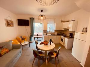 a kitchen and living room with a table and a couch at Aquamarine Maisonette in Siviri