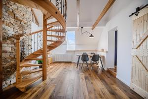 a staircase in a room with a table and chairs at Mountain View Apartment with Sauna in Cerklje na Gorenjskem +27 photos