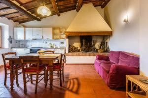 a kitchen and dining room with a table and a couch at Tenuta Poggio ai Mandorli in Greve in Chianti