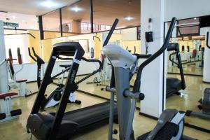 a gym with two treadmills and a treadmill at Marques Plaza Hotel in Pouso Alegre