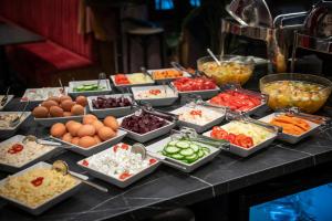 a buffet of different types of food on a table at Hotel Mika Downtown in Budapest