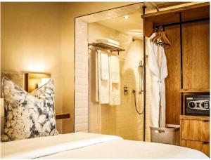 a bedroom with a shower and a bed with a pillow at Sugar Hotel in Cape Town