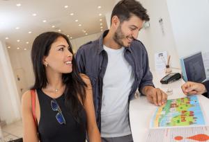 a man and a woman looking at a map at Hb Hotels Orchidea Blu in Rimini