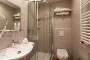 a bathroom with a shower and a sink and a toilet at Hb Hotels Orchidea Blu in Rimini