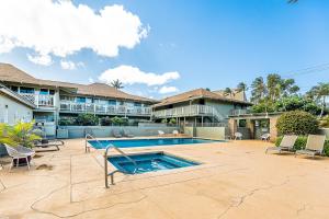 a swimming pool in front of a house at Kihei Bay Surf B212 in Kihei