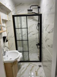 a bathroom with a shower with a sink and a mirror at Taksim Rain Suite in Istanbul +36 photos