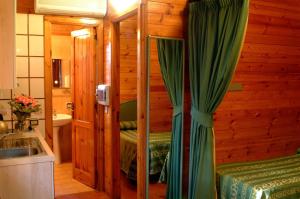 a bathroom with a bed and a sink in a room at Residence Villaggio Verde in Sorrento