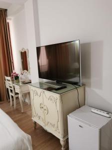 a tv on top of a dresser in a bedroom at Nevis Fundeni in Bucharest