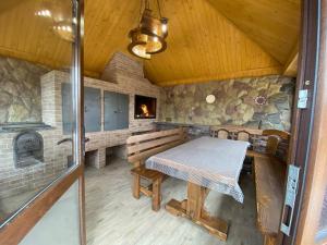 a dining room with a table and a fireplace at Villa OkSun in Skhidnitsa
