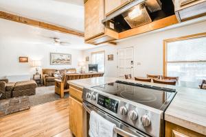 a kitchen with a stove top oven next to a living room at Pandora in Shaver Lake