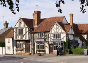 an old building in the middle of a street at The Woolpack Inn in Coggeshall