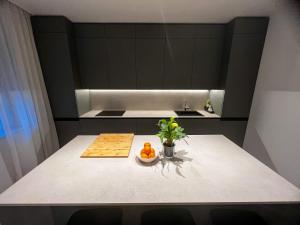 a kitchen with a table with a bowl of fruit on it at Luxury home beach apartament in Split, Croatia in Split