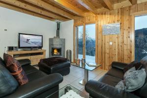 a living room with a couch and a fireplace at Chalet Colonia in La Tzoumaz