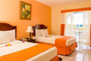 a hotel room with two beds and a window at Bay Gardens Inn in Gros Islet