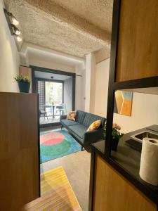 a living room with a couch and a table at INBP109 Mini loft I freeparking I Self Check-in in Budapest