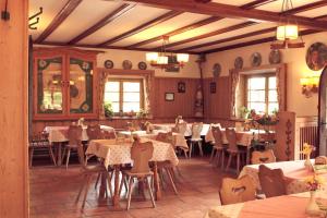 un ristorante con tavoli e sedie in una stanza di Pension Brucker a Aschau im Chiemgau