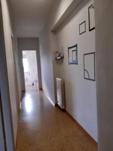 an empty hallway with a radiator and pictures on the wall at Sei Da Noi in Ivrea