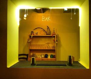 a room with a bar with a shelf and lights at Rifugio Valomagna in Falciano