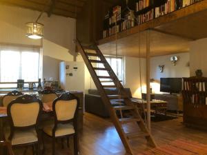 a living room with a wooden table and a spiral staircase at ANTALYA KALEİÇİ TARİHİ LOKASYON BAHÇELİ ÖZEL MÜSTAKİL ev in Antalya