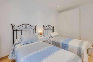 a bedroom with two beds and a window at Apartamento Condal in Blanes +36 photos