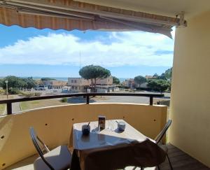 un tavolo e sedie su un balcone con vista di T2 vue Mer - St Pierre la Mer 2PLM67 a Saint Pierre La Mer