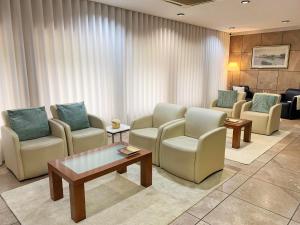 a waiting room with chairs and a table at Hotel Puma in Maia