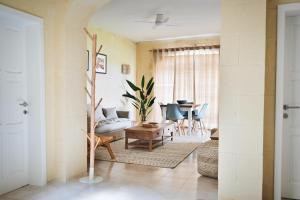 a living room with a table and chairs at Ogygia Suites Gozo in Għarb