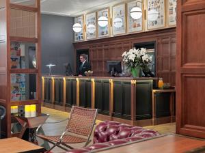 a man in a suit standing at a reception desk at Boutique Hotel H10 Montcada in Barcelona