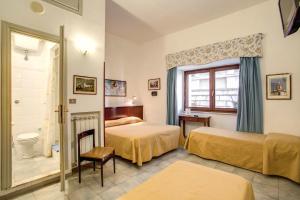 Postel nebo postele na pokoji v ubytování Hotel Primavera