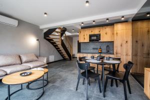 a living room with a couch and a table and chairs at odNova - Holiday home with SPA in Bobolin