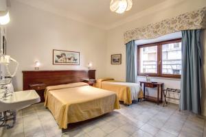Postel nebo postele na pokoji v ubytování Hotel Primavera