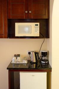 a kitchen with a counter top with a microwave at Bay Gardens Inn in Gros Islet