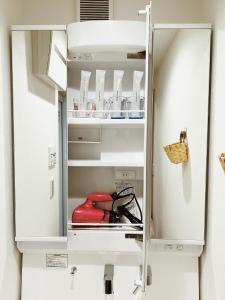 a refrigerator door open with a red appliance inside at 成田羽田空港直行 skytree 上野 asakusa 銀座直行 駅から徒歩8分新築戸建 駐車場付いてない in Tokyo +30 photos