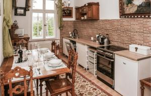 a kitchen with a wooden table and a kitchen with a tableablish at Nice Apartment In Kolobrzeg With Wifi in Kołobrzeg